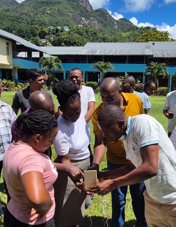 People outside reviewing data.