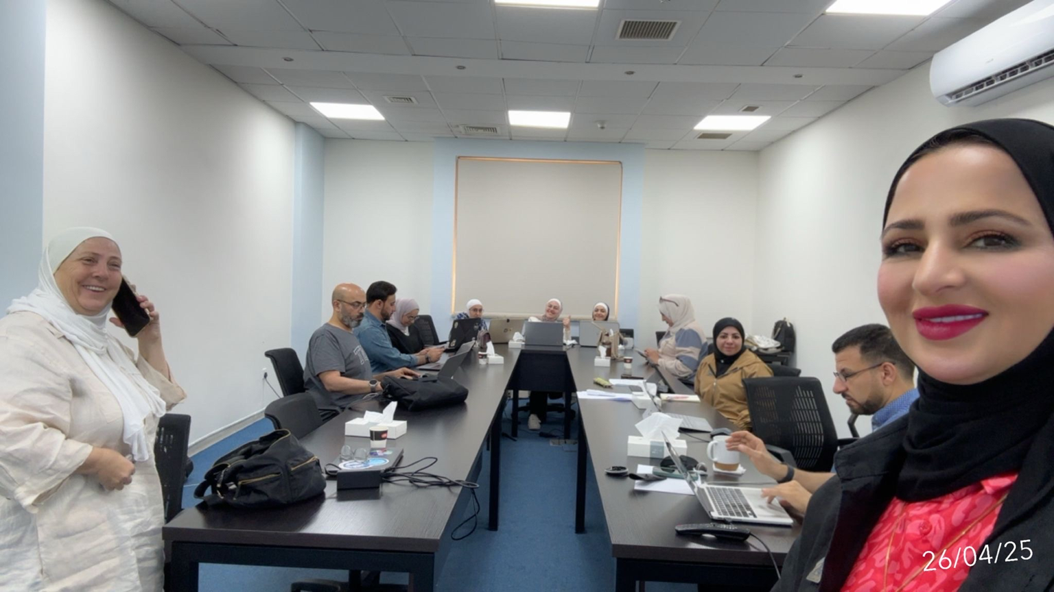 Attendees sitting around the workshop table.