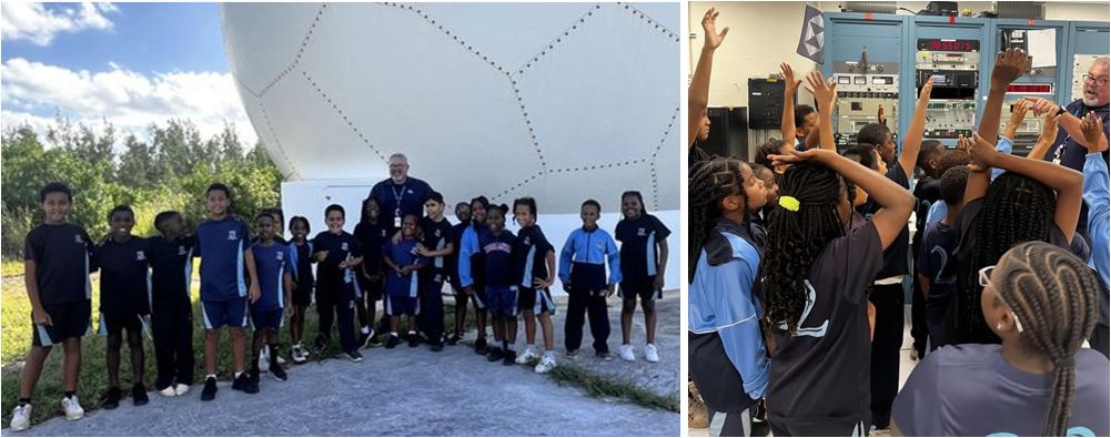Students and teacher posing for photo outside. Students raising their hands in group.