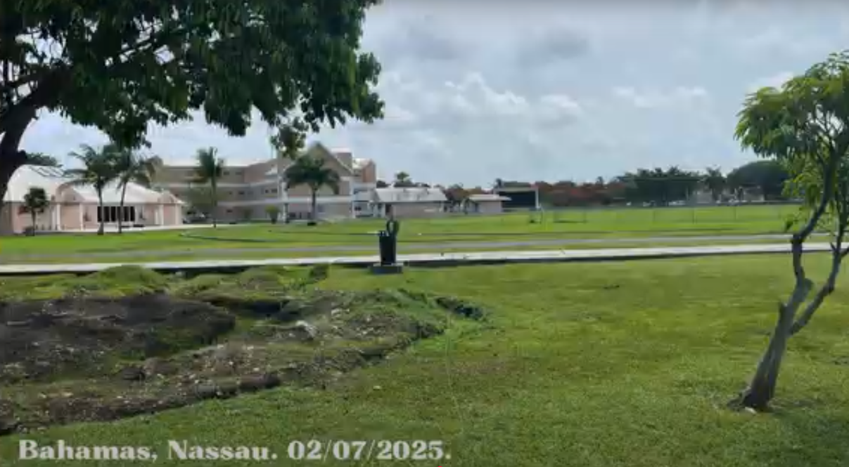 Landscape photo with houses in the distance.
